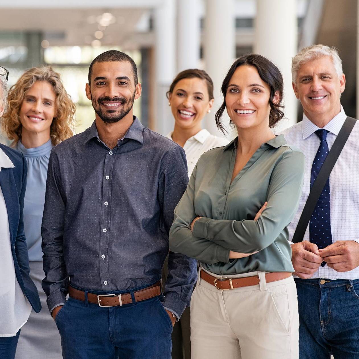 Group of men and women standing proudly, smiling at having graduated from the Mars Venus Coaching certification program