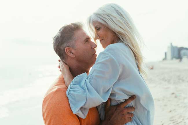 senior couple being intimate at the beach